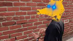 Person with glowing yellow dog mask against brick wall