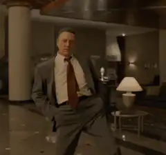 Chris Cooper dancing in a suit