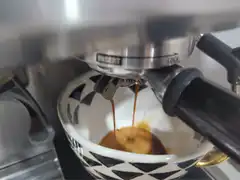 espresso pouring into cup