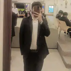 Man in suit taking mirror selfie