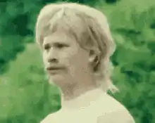 Blonde man with mustache looking confused