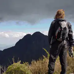 Hiker watching color shifting mountain landscape