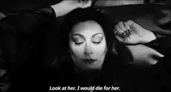 Anjelica Huston lying down with eyes closed