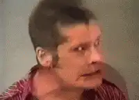 Man with sideburns making a creepy face