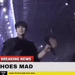 Suga from BTS singing with breaking news overlay