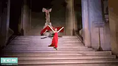 Woman in red dress dancing on stairs