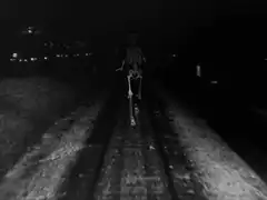 Skeleton running on train tracks