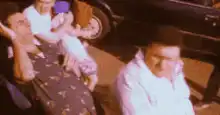 Man on phone with woman and child