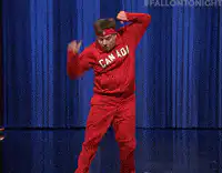 Man in red Canada tracksuit dancing