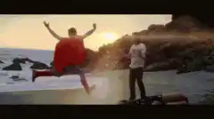 Superman flying into a man on the beach