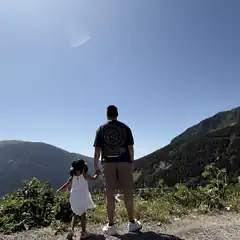 Man and child holding hands on mountain
