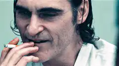 Joaquin Phoenix smoking and smiling