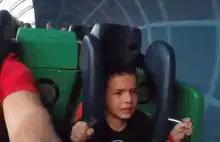 Boy screaming on roller coaster