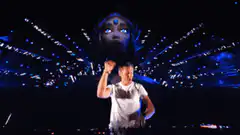 DJ performing with giant floating head