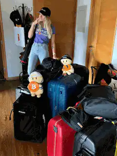 woman with luggage and bitcoin ducks