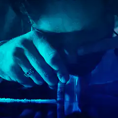 Man snorting cocaine in blue light