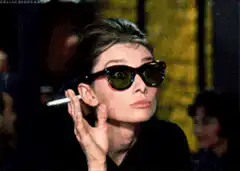 Audrey Hepburn lifts sunglasses