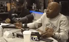 Two men laughing hysterically in a studio