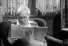 Old man reading newspaper