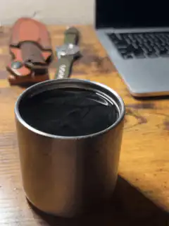 black liquid in metal cup