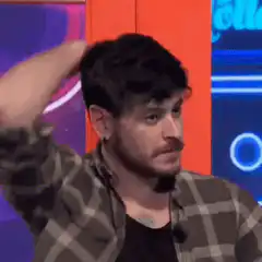 Man wiping sweat from forehead