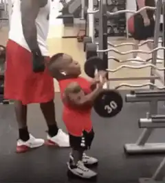 Tiny bodybuilder lifting dumbbell