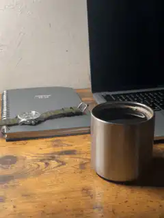 steaming metal coffee cup on desk