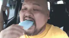Man eating popsicle brain freeze