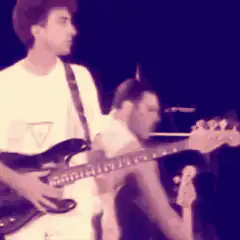 Freddie Mercury playing guitar on stage