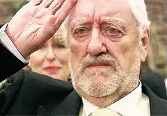 Bernard Hill saluting with a serious face