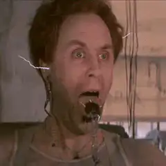 Man getting electrocuted with spider in mouth