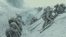 Soldiers climbing snowy hill with rifles