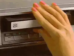 Hand inserts cassette into player