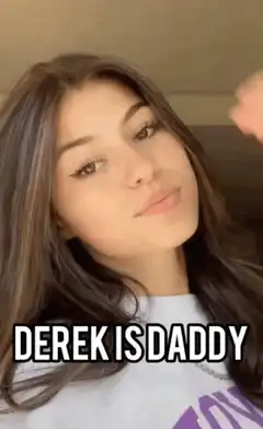 Girl posing with Derek is Daddy text