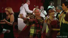 Man in plaid jacket dancing at party