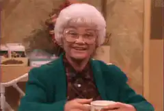 Mrs. Doubtfire smiling with coffee