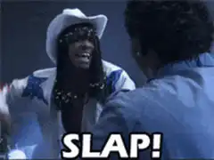 Woman slapping man in blue shirt