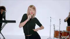 Taylor Swift singing with intense expression