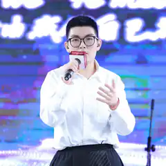 Young man singing on stage with microphone