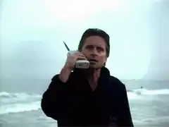 Michael Douglas on phone at beach