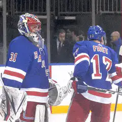 Hockey players high five and hug