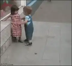 Toddler boy pushes girl against wall