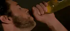man chugging beer from bottle