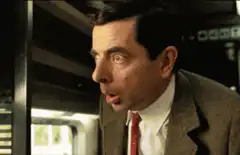 Mr. Bean looks up in shock