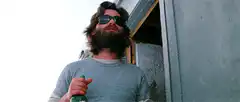 Bearded man drinking from a bottle
