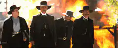 Four men walking away from explosion