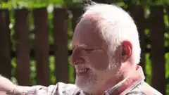Old man squinting in sunlight