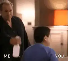 Man sprays boy with water bottle