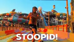 Man running on water slide yelling STOOPID