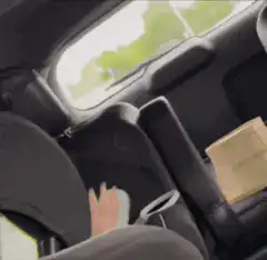 Baby hand waving in car seat